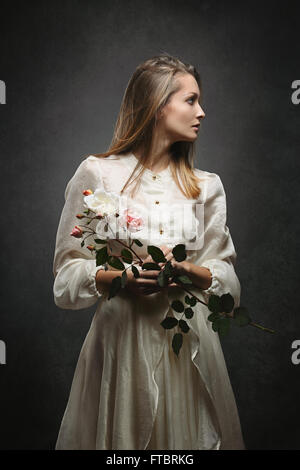 Beautiful woman with victorian dress turns sideaways. Studio Shot Stock Photo