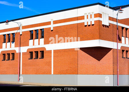 Ahus, Sweden - March 20, 2016: Architectural detail of the Absolut Company factory, the place where Absolut Vodka is made. Red b Stock Photo