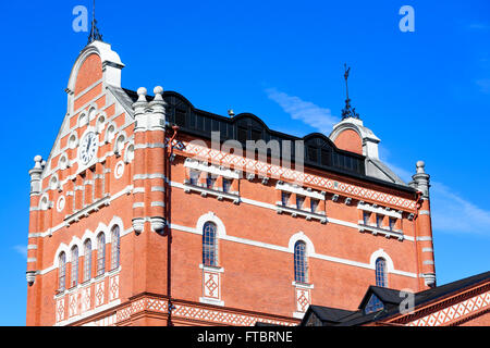 Ahus, Sweden - March 20, 2016: Architectural detail of the Absolut Company factory, the place where Absolut Vodka is made. Red b Stock Photo