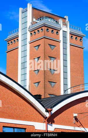 Ahus, Sweden - March 20, 2016: Architectural detail of the Absolut Company factory, the place where Absolut Vodka is made. Red b Stock Photo