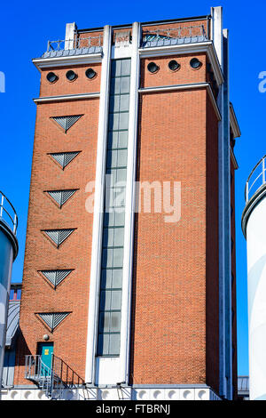 Ahus, Sweden - March 20, 2016: Architectural detail of the Absolut Company factory, the place where Absolut Vodka is made. Red b Stock Photo