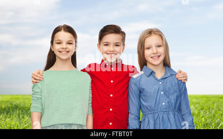 happy boy and girls hugging Stock Photo