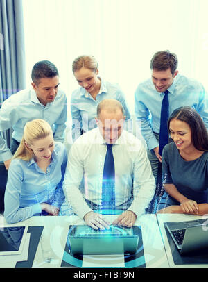 smiling business people with laptop in office Stock Photo