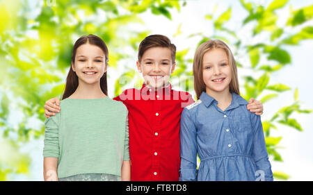 happy boy and girls hugging Stock Photo