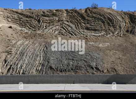 Deformed rock layers in road cut along San Andres fault County of Los Angeles Stock Photo