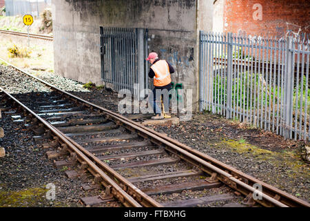 Whitehead, Co Antrim,UK 28th March 2016 . A railwayman Changing signals by hand using a lever Stock Photo