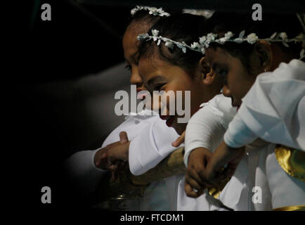 Filipino children dressed as angels participate at the Salubong-the traditional meeting of the Blessed Mother and the resurrected Christ-during the Easter Vigil celebration at Baclaran Church in Paranaque. Easter Vigil was held in the hours of darkness at the evening of Black Saturday until early morning of Easter Sunday. It begins with a Service of Light where an Easter fire is kindled and the Paschal Candle is blessed and lit that signifies Christ as the light and life. It will conclude with the Eucharistic celebration with the renewal of Baptismal promises. (Photo by Marlo Cueto/Pacific Pre Stock Photo