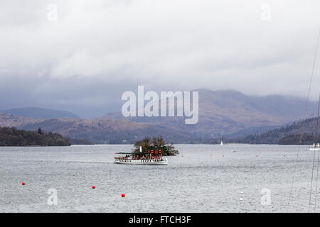 Lake Windermere Cumbria 27th March  2016 . UK Weather -Clouds clearing but still on fells above Lake Windermere  -Looking north from Bowness Bay Passenger cruises boats busey with weekend visitors-The Passnger steamer The Tern Ibuilt 1891) arriving at Bowness  Credit:  Gordon Shoosmith/Alamy Live News Stock Photo