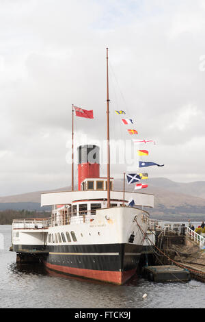 Loch Lomond, Scotland, UK. 27th March, 2016. UK weather: people  enjoying a bright breezy Easter Sunday of sunshine and showers on board Loch Lomond's Maid of the Loch.  The Maid of the Loch is the last paddle steamer built in Britain and, run entirely by volunteers, is open to the public for free as a static attraction with a cafe/bar and function suite on board.  Volunteers are working hard to bring her back into steam operation.  A fundraising campaign to 'Help the Maid to Sail Again', alongside visitor donations helps to raise money for the restoration Stock Photo