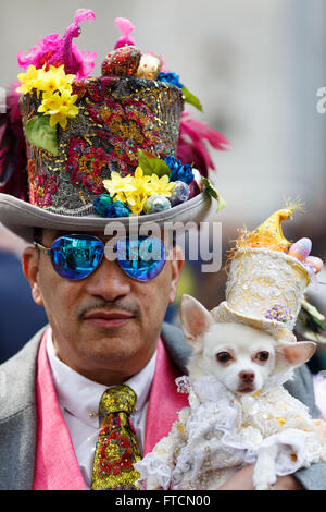 New York, USA. 27th Mar, 2016. A man and his dog attend New York's annual Easter Bonnet Parade held on the Fifth Avenue in Manhattan of New York City, the United States, March 27, 2016. With a history of more than 100 years, the New York Easter Bonnet Parade is held annually on the 5th Avenue near the Saint Patrick's Cathedral. Adults, children and even pets in creative colorful bonnets and outfits participate in the event, which also attract thousands of New York residents and tourists. Credit:  Li Muzi/Xinhua/Alamy Live News Stock Photo