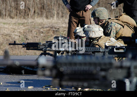 BUCHAREST, Romania (Feb. 26, 2015) U.S. Marines from the Marine security guard detachment at the U.S. Embassy Bucharest, Romania, fire an M240 machine gun at the Romanian intelligence service shooting range in Bucharest, Feb. 26, 2015. The Marines conducted small arms marksmanship training with host nation forces during an embassy engagement to familiarize both forces on weapons normally used during security operations. (U.S. Marine Corps photo by Sgt. Esdras Ruano/Released) Stock Photo