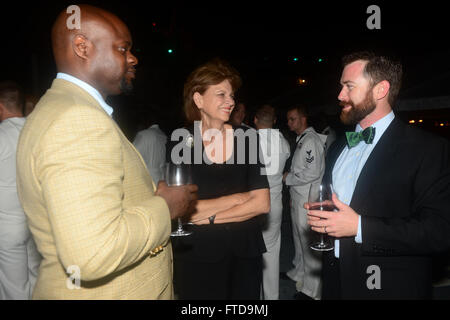 150304-N-RB579-254 LUANDA, Angola (March 4, 2015) Ambassador Helen Meagher La Lime, US Ambassador to the Republic of Angola (center), speaks with an embassy attaché (left) and civil service mariner James Regan, Spearhead's Chief Mate (right) at an embassy function held onboard the Military Sealift Command's joint high-speed vessel USNS Spearhead as part of Africa Partnership Station, March 4, 2015. Spearhead is on a scheduled deployment to the U.S. 6th Fleet area of operations in support of the international collaborative capacity-building program Africa Partnership Station. (U.S. Navy photo b Stock Photo