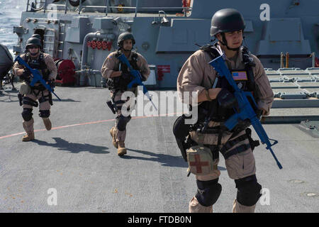 150401-N-VC236-060 MEDITERRANEAN SEA (April 1, 2015) - Logistics Specialist Seaman Gregory Micalizzi, from Boston, right, Operations Specialist 2nd Class Jordan Torres, from Brooksville, Florida, center, and Operations Specialist 3rd Class Will Farmer, from Columbia, South Carolina,  investigate the ship's forecastle during a visit, board, search and seizure drill aboard the Arleigh Burke-class guided-missile destroyer USS Farragut (DDG 99) April 1, 2015. Farragut, homeported in Mayport, Florida, is conducting naval operations in the U.S. 6th Fleet area of operations in support of U.S. nationa Stock Photo