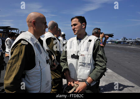 150402-N-GR120-605 MEDITERRANEAN SEA (April 02, 2015) - Lt. Ariel Klainerman, assigned to the Knighthawks of Strike Fighter Attack Squadron (VFA) 136, discusses flight operations with distinguished visitors during an air power demonstration on the flight deck of the Nimitz-class aircraft carrier USS Theodore Roosevelt (CVN 71) April 02, 2015. TR hosted members of the Israeli and Cyprus government and military as part of the Distinguished Visitors program. Theodore Roosevelt deployed from Norfolk and will execute a homeport shift to San Diego at the conclusion of deployment. Theodore Roosevelt  Stock Photo