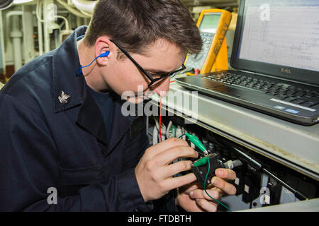 150422-N-XB010-010 MEDITERRANEAN SEA (April 22, 2015) Gas Turbine Systems Technician (Electrical) 2nd Class Chase Bateman, from Durham, North Carolina, performs maintenance in a main engine space aboard USS Laboon (DDG 58) April 22, 2015. Laboon, an Arleigh Burke-class guided-missile destroyer, homeported in Norfolk, is conducting naval operations in the U.S. 6th Fleet area of operations in support of U.S. national security interests in Europe. (U.S. Navy photo by Mass Communication Specialist 3rd Class Desmond Parks/Released) Stock Photo