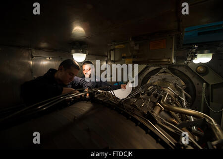 150517-N-FQ994-025 MEDITERRANEAN SEA (May 17, 2015) Gas Turbine Systems (Mechanical) 3rd Class Landon Scobey, from Los Angeles, left, and Gas Turbine Systems (Mechanical) 1st Class James Wainio, from Ashland, Wisconsin, perform maintenance on a gas turbine engine aboard USS Ross (DDG 71) May 17, 2015. Ross, an Arleigh Burke-class guided-missile destroyer, forward-deployed to Rota, Spain, is conducting naval operations in the U.S. 6th Fleet area of operations in support of U.S. national security interests in Europe. (U.S. Navy photo by Mass Communication Specialist 3rd Class Robert S. Price/Rel Stock Photo