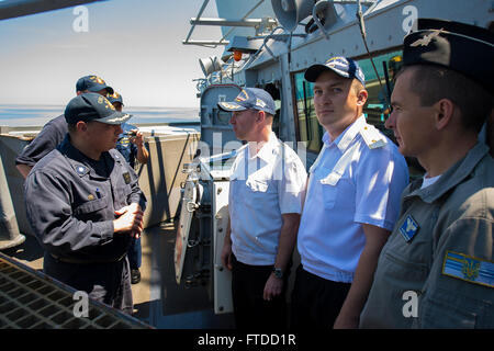 150601-N-FQ994-316 BLACK SEA (June 1, 2015) Cmdr. Tadd Gorman, commanding officer USS Ross (DDG 71), left, speaks with officers from the Ukrainian navy Frigate Hetman Sahaydachniy (U 130) June 1, 2015. Ross, an Arleigh Burke-class guided-missile destroyer, forward-deployed to Rota, Spain, is conducting naval operations in the U.S. 6th Fleet area of operations in support of U.S. national security interests in Europe. (U.S. Navy photo by Mass Communication Specialist 3rd Class Robert S. Price/Released) Stock Photo