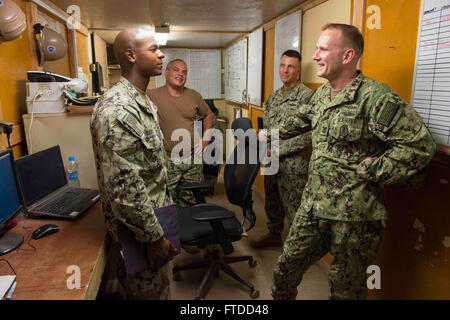 150603-N-OX801-171 CAMP LEMONNIER, Djibouti (June 3, 2015) Naval Forces Europe-Africa Fleet Master Chief Steven Giordano, right, speaks with Utilitiesman 2nd Class Luis Suero, from New York, New York, left, Construction Mechanic 2nd Class Joel Mazola, from Orlando, Florida, second from left, and Chief Equipment Operator El Sayre, from Nicholasville, Kentucky, during a visit to Camp Lemonnier, Djibouti, June 3, 2015. Giordano recognized and presented his personal coin to Suero on behalf of NMCB 14 leadership for his exemplary performance within the command. (U.S. Navy photo by Mass Communicatio Stock Photo