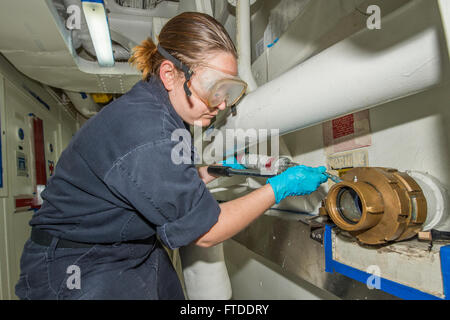 150616-N-XB010-024 MEDITERRANEAN SEA (June 16, 2015) Yeoman 2nd Class Lindsei Spagnola, from St. Petersburg, Florida, performs maintenance on the aft discharge valve aboard USS Laboon (DDG 58) June 16, 2015. Laboon, an Arleigh Burke-class guided-missile destroyer, homeported in Norfolk, is conducting naval operations in the U.S. 6th Fleet area of operations in support of U.S. national security interests in Europe. (U.S. Navy photo by Mass Communication Specialist 3rd Class Desmond Parks) Stock Photo