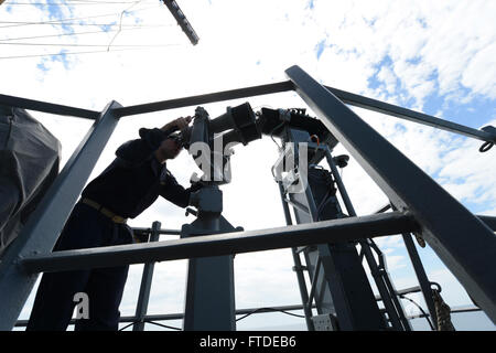 150630-N-XB010-045 BLACK SEA (June 30, 2015) Chief Information Specialist John Vercelli, from Virginia Beach, Virginia, searches for Turkish frigate TCG Yildirim (F-243) through the “Big Eyes” during a surface combat exercise aboard USS Laboon (DDG 58) with the Turkish navy June 30, 2015. Laboon, an Arleigh Burke-class guided-missile destroyer, homeported in Norfolk, is conducting naval operations in the U.S. 6th Fleet area of operations in support of U.S. national security interests in Europe. (U.S. Navy photo by Mass Communication Specialist 3rd Class Desmond Parks) Stock Photo