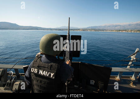 150713-N-FQ994-037 SOUDA BAY, Greece (July 13, 2015) Gunner's Mate 2nd Class Megan Leary, from Syracuse, New York, mans a .50-caliber machine gun as part of a Small Craft Action Team aboard USS Ross (DDG 71) July 13, 2015. Ross, an Arleigh Burke-class guided-missile destroyer, forward-deployed to Rota, Spain, is conducting naval operations in the U.S. 6th Fleet area of operations in support of U.S. national security interests in Europe. (U.S. Navy photo by Mass Communication Specialist 3rd Class Robert S. Price/Released) Stock Photo