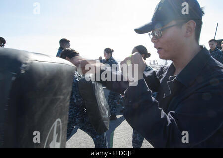 151018-N-AX546-013 BLACK SEA (Oct. 18, 2015) Seaman Yin Jin, from San Francisco,  executes a jab during a security action force basic qualification aboard USS Porter (DDG 78) Oct. 18, 2015. Porter, an Arleigh Burke-class guided-missile destroyer, forward-deployed to Rota, Spain, is on a routine patrol conducting naval operations in the U.S. 6th Fleet area of operations in support of U.S. national security interests in Europe. (U.S. Navy photo by Mass Communication Specialist 1st Class Sean Spratt/Released) Stock Photo