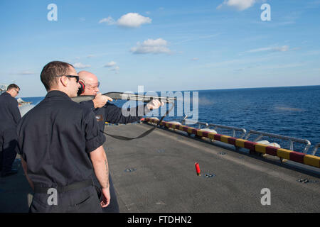 151031-N-AX638-398 MEDITERRANEAN SEA (Oct. 31, 2015) Chief Warrant Officer 2 Mike Hayden, from Weymouth, Massachusetts, Gunner of the amphibious assault ship USS Kearsarge (LHD 3), fires an M-500 shotgun while Gunner's Mate 2nd Class Kyle Orr, from Cedar Rapids, Iowa, acts as line coach during a small arms live-fire exercise on the flight deck aboard Kearsarge (LHD 3), Oct. 31, 2015. Kearsarge, deployed as part of the Kearsarge Amphibious Ready Group, is conducting naval operations in the U.S. 6th Fleet area of operations in support of U.S. national security interests in Europe. (U.S. Navy Pho Stock Photo