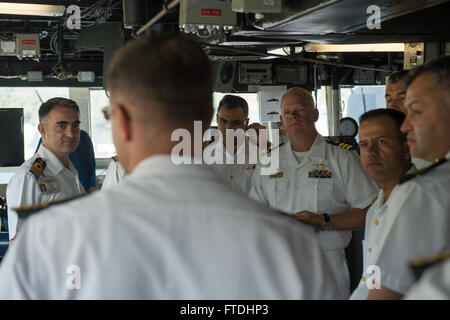 151031-N-TC720-271 AKSAZ, Turkey (Oct. 31, 2015) Cmdr. Charles Hampton, commanding officer of USS Donald Cook (DDG 75) gives Turkish naval officers a tour of the ship's bridge Oct. 31, 2015. Donald Cook, an Arleigh Burke-class guided-missile destroyer, forward deployed to Rota, Spain is conducting a routine patrol in the U.S. 6th Fleet area of operations in support of U.S. national security interests in Europe. (U.S. Navy photo by Mass Communication Specialist 3rd Class Mat Murch/Released) Stock Photo