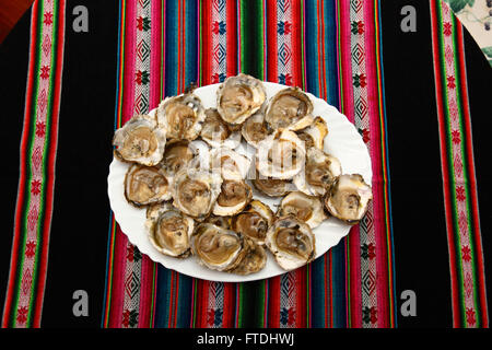 Fresh oysters on plate in seafood restaurant, Vigo, Galicia, Spain