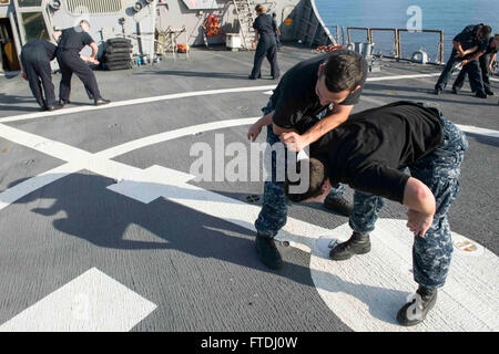 151117-N-TC720-088 MEDITERRANEAN SEA (Nov. 17, 2015) Seaman Jacob Sanchez, form McMinville, Oregon, left, practices takedowns on Operations Specialist Seaman Ryan Cornell, from Kansas City, Missouri, during a shipboard reaction force basic course aboard USS Donald Cook (DDG 75) Nov. 17, 2015. Donald Cook, an Arleigh Burke-class guided-missile destroyer, forward deployed to Rota, Spain is conducting a routine patrol in the U.S. 6th Fleet area of operations in support of U.S. national security interests in Europe. (U.S. Navy photo by Mass Communication Specialist 3rd Class Mat Murch/Released) Stock Photo