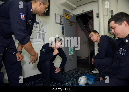 151202-N-FP878-080 MEDITERRANEAN SEA (Dec. 2, 2015) Hospital Corpsman 2nd  Class Alex Penegar, center-left, of Kearns, Utah, instructs Sailors on the proper way of performing CPR aboard USS Carney (DDG 64), December 2, 2015.  Carney, an Arleigh Burke-class guided missile destroyer, forward deployed to Rota, Spain, is conducting a routine patrol in the U. S. 6th Fleet area of operations in support of U.S. national security interests in Europe.  (U.S. Navy photo by Mass Communication Specialist 1st  Class Theron J. Godbold/Released) Stock Photo