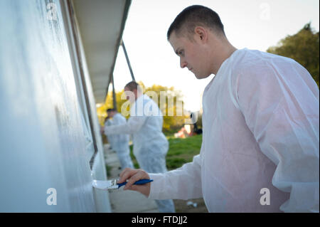 151207-N-ZN152-122 RUSILICA, CROATIA (Dec. 7, 2015) Aviation Electronics Technician Airman N. Hilliard, assigned to aircraft carrier USS Harry S. Truman (CVN 75) removes graffiti from the Juraj Bonaci School for children with special needs during a community relations project. Harry S. Truman Carrier Strike Group is conducting naval operations in the U.S. 6th Fleet area of operations in support of U.S. national security interests in Europe and Africa. (U.S. Navy photo by Mass Communication Specialist 1st Class E.R. Scott/Released) Stock Photo