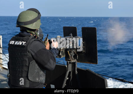 151218-N-XT273-311 MEDITERRANEAN SEA (Dec. 18, 2015) A Sailor aboard USS Ross (DDG 71) fires a .50-caliber machine gun during a general quarters drill in the Mediterranean Sea Dec. 18, 2015. Ross, an Arleigh Burke-class guided-missile destroyer, forward deployed to Rota, Spain, is conducting a routine patrol in the U.S. 6th Fleet area of operations in support of U.S. national security interests in Europe. (U.S. Navy photo by Mass Communication Specialist 2nd Class Justin Stumberg/Released) Stock Photo