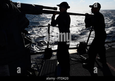 151230-N-FP878-168 MEDITERRANEAN SEA (Dec. 30, 2015) Fire Controlman 2nd Class Azareel Castro from Houston, and Fire Controlman 2nd Class Stephanie Drake from Pearland, Texas, install the barrel for a mark 38 mod 2 25mm machine gun during a maintenance check aboard USS Carney (DDG 64), Dec. 30, 2015. Carney, an Arleigh Burke-class guided-missile destroyer, forward deployed to Rota, Spain, is conducting a routine patrol in the U. S. 6th Fleet area of operations in support of U.S. national security interests in Europe. (U.S. Navy photo by Mass Communication Specialist 1st Class Theron J. Godbold Stock Photo