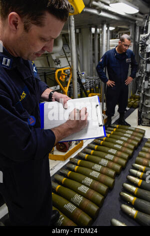 160204-N-FP878-090 MEDITERRANEAN SEA (Feb. 4, 2016) Lt. James Black from Detroit, and Gunner’s Mate 1st Class Armando Rodriguez from the Bronx, New York, take inventory of five inch ammunition aboard USS Carney (DDG 64) Feb. 4, 2016. Carney, an Arleigh Burke-class guided-missile destroyer, forward deployed to Rota, Spain, is conducting a routine patrol in the U. S. 6th Fleet area of operations in support of U.S. national security interests in Europe. (U.S. Navy photo by Mass Communication Specialist 1st Class Theron J. Godbold/Released) Stock Photo