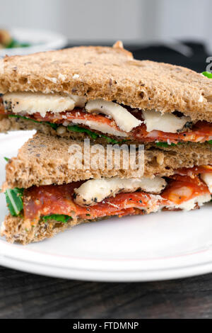 Italian salami and sheep cheese sandwich with brown bread. Stock Photo