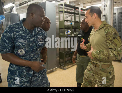 160225-N-WV703-184 ATLANTIC OCEAN (Feb. 25, 2016) Aviation Boatswain's Mate 2nd Class Koffi O. Atanley, left), acts as a translator for Machinery Technician 2nd Class Paul Avella, right, a member of the U.S. Coast Guard Law Enforcement Detachment, while conducting pressure point and escort training with Capt. Tanyi Kuddus Taku, center-right, and Lt. Issa Ibrahim, Cameroon customs officers embarked aboard USNS Spearhead (T-EPF 1), Feb. 25, 2016. The Military Sealift Command expeditionary fast transport vessel USNS Spearhead is on a scheduled deployment in the U.S. 6th Fleet area of operations t Stock Photo