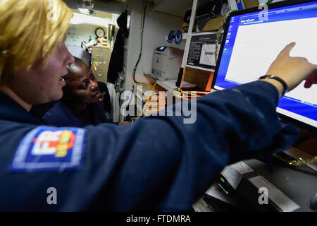 160226-N-FP878-002 MEDITERRANEAN SEA (Feb. 26, 2016) Lt. j.g. Jessica Bronson, from Longview, Texas, gives Ship’s Serviceman Seaman Gloria Crentsil, from The Bronx, New York, training on the Navy Cash system aboard USS Carney (DDG 64) Feb. 26, 2016. Carney, an Arleigh Burke-class guided-missile destroyer, forward deployed to Rota, Spain, is conducting a routine patrol in the U. S. 6th Fleet area of operations in support of U.S. national security interests in Europe. (U.S. Navy photo by Mass Communication Specialist 1st Class Theron J. Godbold/Released) Stock Photo