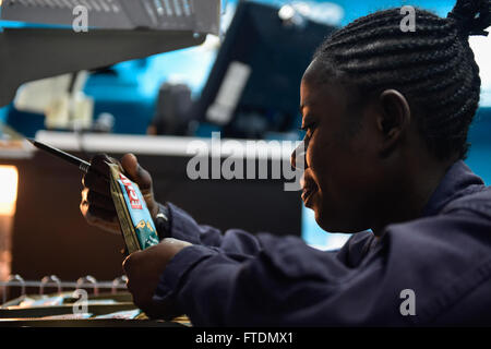 160229-N-FP878-043 MEDITERRANEAN SEA (Feb. 29, 2016) Ship’s Serviceman Seaman Gloria Crentsil, from The Bronx, New York, conducts end of month inventory in the ships store aboard USS Carney (DDG 64) Feb. 29, 2016. Carney, an Arleigh Burke-class guided-missile destroyer, forward deployed to Rota, Spain, is conducting a routine patrol in the U. S. 6th Fleet area of operations in support of U.S. national security interests in Europe. (U.S. Navy photo by Mass Communication Specialist 1st Class Theron J. Godbold/Released) Stock Photo