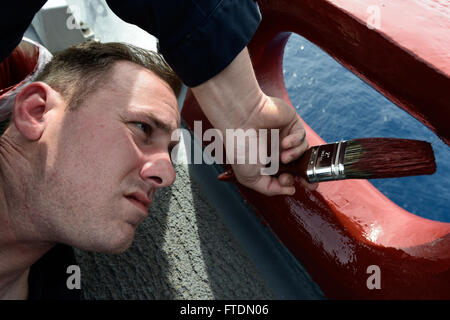 160302-N-FP878-031 MEDITERRANEAN SEA (March 2, 2016) Sonar Technician (Surface) 1st Class Matthew Nance from West Monroe, Louisiana, conducts top side preservation aboard USS Carney (DDG 64) March 2, 2016. Carney, an Arleigh Burke-class guided-missile destroyer, forward deployed to Rota, Spain, is conducting a routine patrol in the U. S. 6th Fleet area of operations in support of U.S. national security interests in Europe. (U.S. Navy photo by Mass Communication Specialist 1st Class Theron J. Godbold/Released) Stock Photo