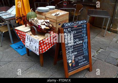 Spanish language menu with prices in Euros outside typical seafood restaurant / cafe, Vigo, Galicia, Spain Stock Photo