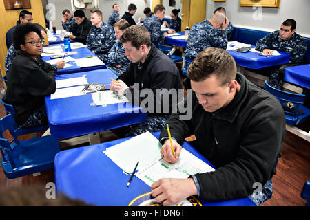 160310-N-FP878-004 PALMA DE MALLORCA, Spain (March 10, 2016) Sailors prepare to take the cycle 231 E-5 Navywide advancement exam aboard USS Carney (DDG 64) March 10, 2016. Carney, an Arleigh Burke-class guided-missile destroyer, forward deployed to Rota, Spain, is conducting a routine patrol in the U. S. 6th Fleet area of operations in support of U.S. national security interests in Europe. (U.S. Navy photo by Mass Communication Specialist 1st Class Theron J. Godbold/Released) Stock Photo