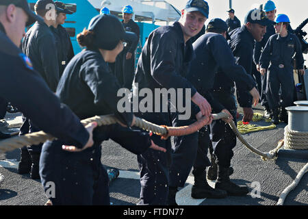 160311-N-FP878-051 PALMA DE MALLORCA, Spain (March 11, 2016) Sailors heave mooring lines aboard USS Carney (DDG 64) as the ship departs Palma De Mallorca, Spain March 11, 2016. Carney, an Arleigh Burke-class guided-missile destroyer, forward deployed to Rota, Spain, is conducting a routine patrol in the U. S. 6th Fleet area of operations in support of U.S. national security interests in Europe. (U.S. Navy photo by Mass Communication Specialist 1st Class Theron J. Godbold/Released) Stock Photo