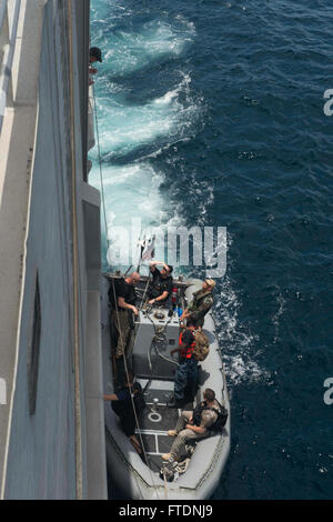 160321-N-WV703-261 GULF OF GUINEA (March 21, 2016) - Sailors assigned to USNS Spearhead (T-EPF 1) and a Royal Netherlands marine corps member pull alongside Spearhead during a boarding scenario exercise with the Gabon Navy March 21, as part of Exercise Obangame/Saharan Express 2016.. Obangame/Saharan Express, one of three African regional express series exercises facilitated by U.S. Naval Forces Europe-Africa/U.S. 6th Fleet, seeks to increase regional cooperation, maritime domain awareness, information sharing practices and improve interoperability among participating forces in order to enhanc Stock Photo