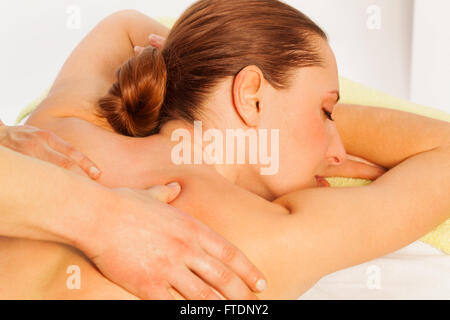 Portrait of woman in spa salon getting massage Stock Photo