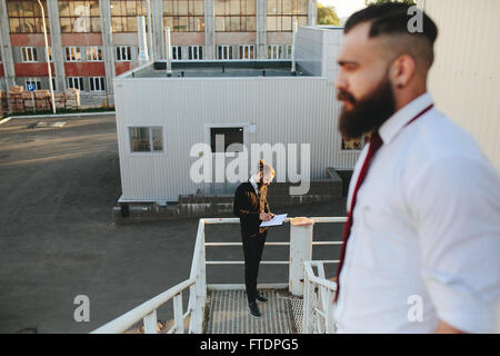 Two bearded businessman looking at something Stock Photo