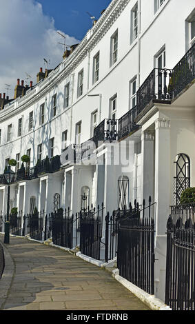 Gleaming white townhouses on a Chelsea London residential crescent. Stock Photo