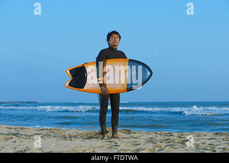 Japanese surfer portrait on the beach Stock Photo