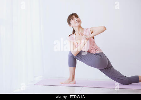 Young Japanese woman practicing yoga Stock Photo