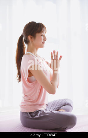 Young Japanese woman practicing yoga Stock Photo